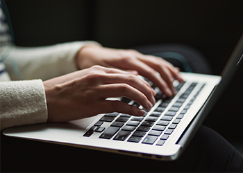 Person typing on laptop